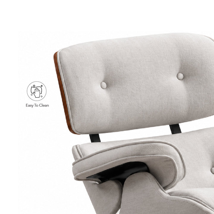 Close-up of a light beige upholstered lounge chair with tufted backrest, wooden side trim, and black metal support legs on a white background. A small 'Easy To Clean' icon appears to the left.
