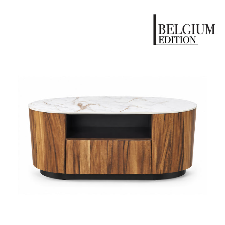 An oval-shaped coffee table with a white marble top, a warm brown wood grain body, and a black open shelf and base, shown on a white background with the 'BELGIUM EDITION' brand logo in the top right corner.