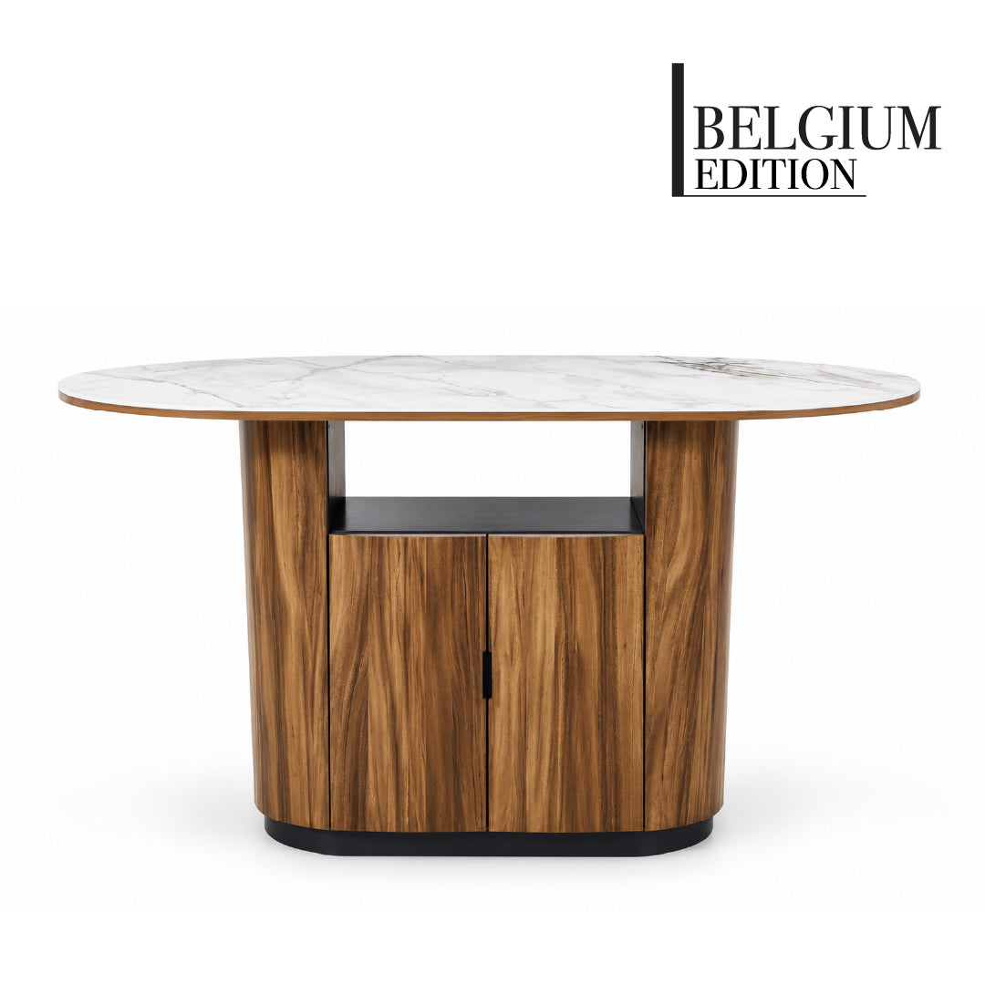 An oval island table with a white sintered stone top and a dark brown Solid Rubberwood and Monkey Pod Wood Veneer base featuring two cabinet doors and an open shelf, shown on a white background, front view of the island table