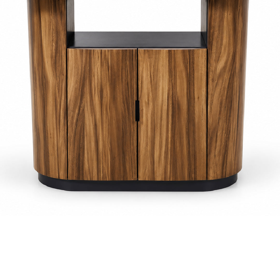 Close-up of the lower cabinet section of a modern wooden island table base, showing two solid rubberwood and monkey pod wood veneer base doors with a slim black handle and a black base.
