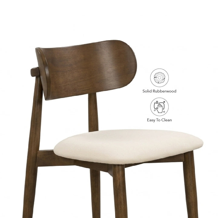 A mid-century modern wooden dining chair with a curved backrest, dark brown rubberwood frame, and a cream-colored upholstered seat cushion. Two circular icons on the right highlight its features: 'Solid Rubberwood' and 'Easy To Clean'.