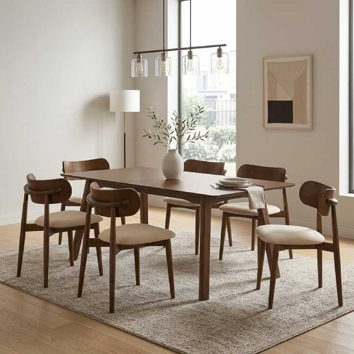 A mid-century modern dining set consisting of a rectangular wooden table and six matching chairs with cream upholstered seats, styled in a bright, contemporary dining room.