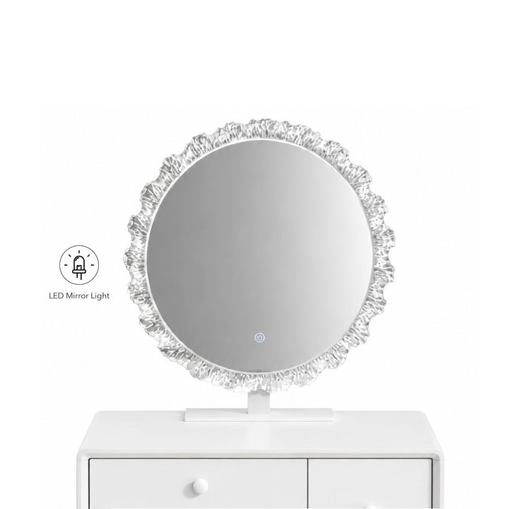 A round LED vanity mirror with a textured, ruffled silver frame, shown resting on a white drawer cabinet against a white background. A small graphic icon on the left indicates the built-in LED mirror light.