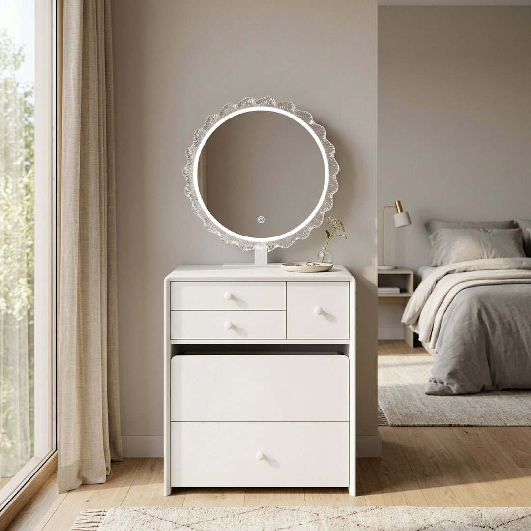 A white three-drawer dresser with a round backlit LED vanity mirror, styled in a bright, modern bedroom setting.