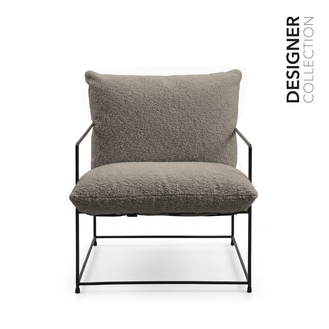 A modern lounge chair with a textured gray bouclé seat cushion and backrest, supported by a slim black metal frame, shown against a plain white background with 'DESIGNER COLLECTION' text on the right.