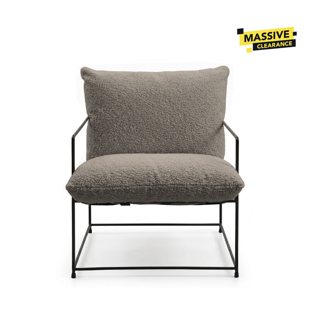 A modern lounge chair with a textured gray bouclé seat cushion and backrest, supported by a slim black metal frame, shown against a plain white background.
