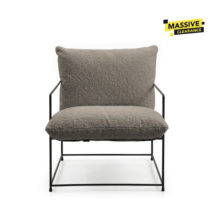 A modern lounge chair with a textured gray bouclé seat cushion and backrest, supported by a slim black metal frame, shown against a plain white background.