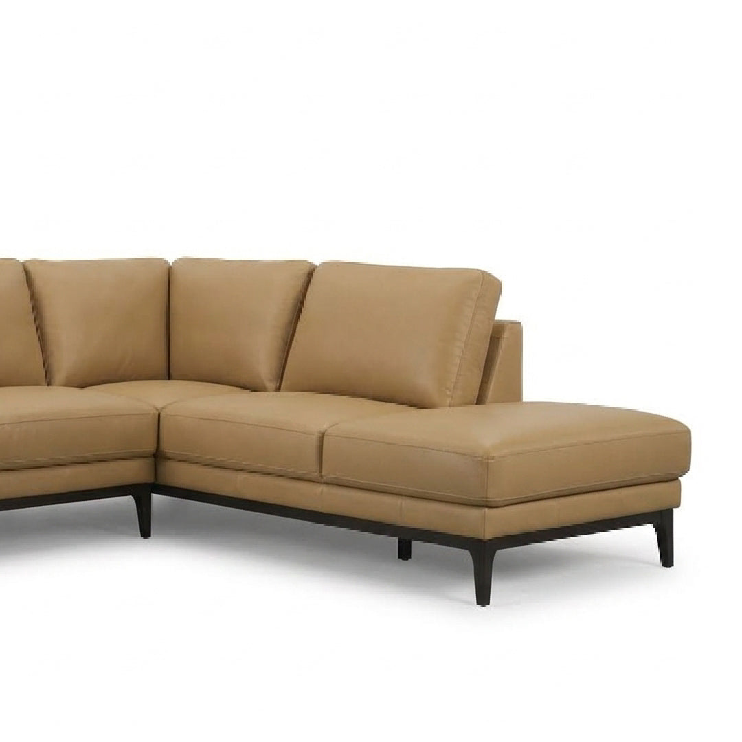 A modern sectional sofa in tan leather with a chaise lounge on the right side and dark tapered legs, shown against a plain white background.