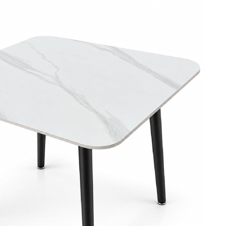 A modern square table with rounded corners, featuring a white marble-patterned top and slim black legs, shown on a clean white background.