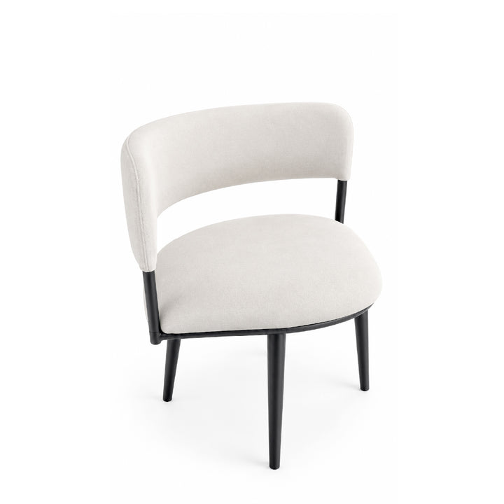 A modern accent chair with a curved backrest and seat upholstered in a light beige fabric, supported by slim black metal legs, shown against a plain white background.