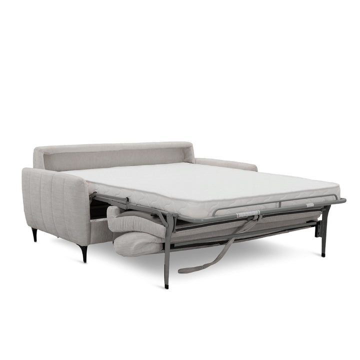 A light khaki upholstered sofa bed with its mattress pulled out onto a metal frame, shown on a clean white background.