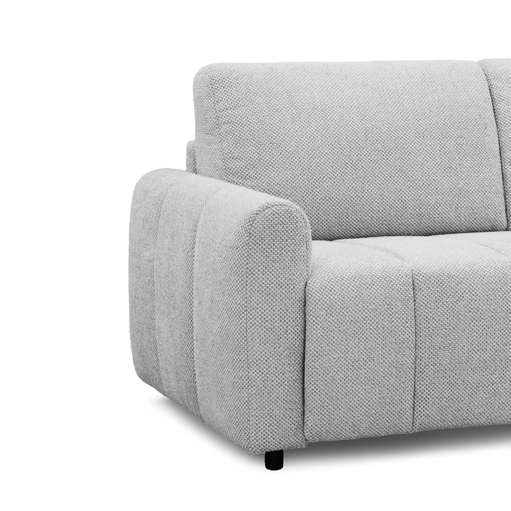 Close-up of a light gray textured fabric sofa with a rounded armrest and clean modern lines on a white background.