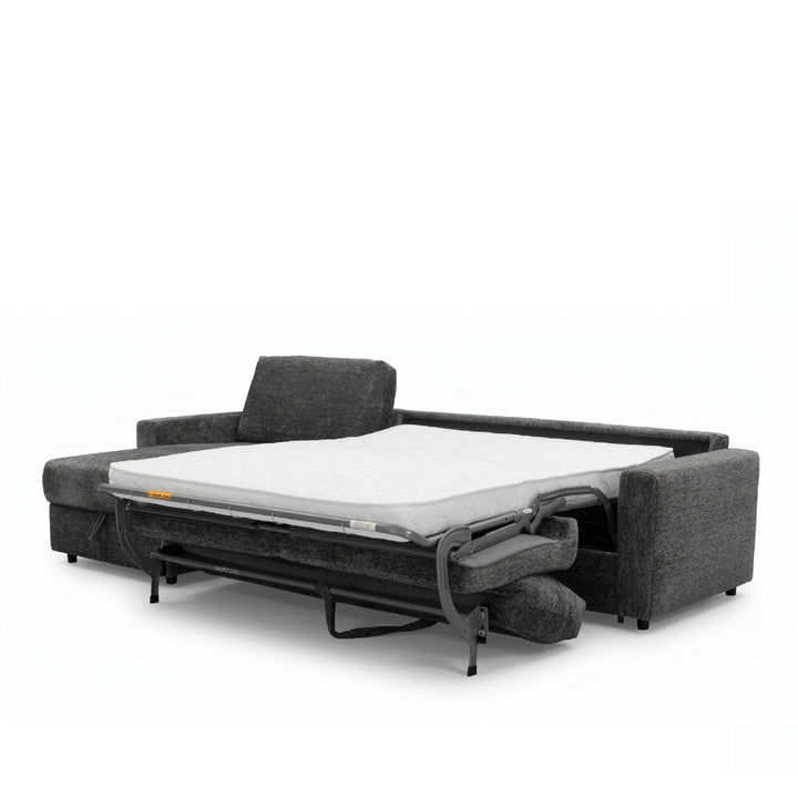 A dark gray upholstered sofa bed shown partially unfolded to reveal a white mattress and metal support frame, photographed on a clean white studio background.