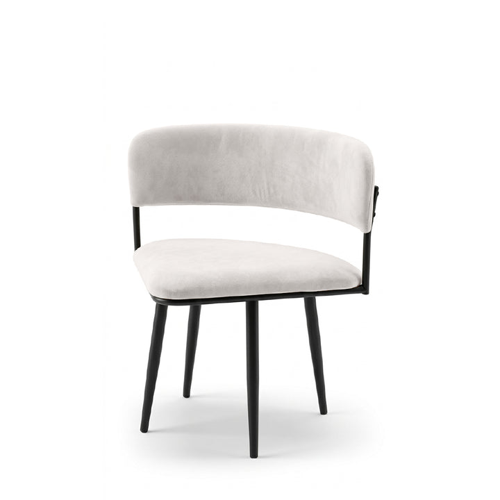 A modern dining chair with a curved light beige upholstered backrest and seat, supported by a black metal frame and tapered black legs, shown against a plain white background.