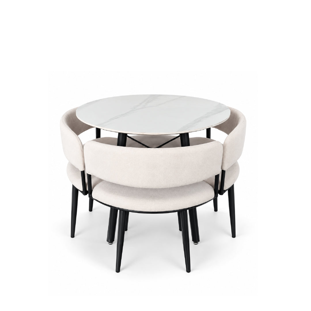 A modern round dining table with a white marble-look top and four upholstered chairs in a light beige fabric, all with black legs, shown on a white background.