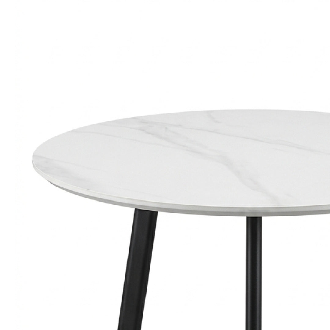 A close-up of a round dining table with a white marble-patterned top and black metal legs, shown against a plain white background.