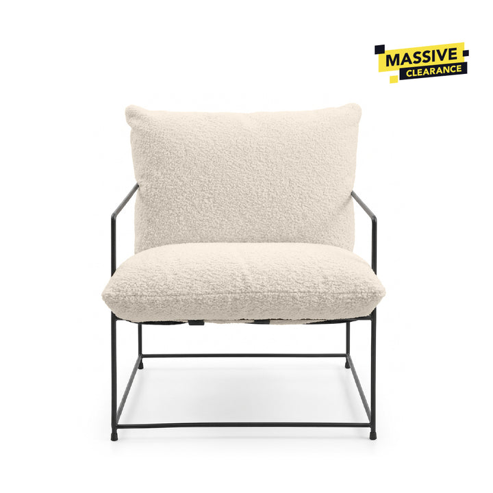 A modern accent chair with a textured cream bouclé seat cushion and backrest, supported by a slim black metal frame, shown against a plain white background.